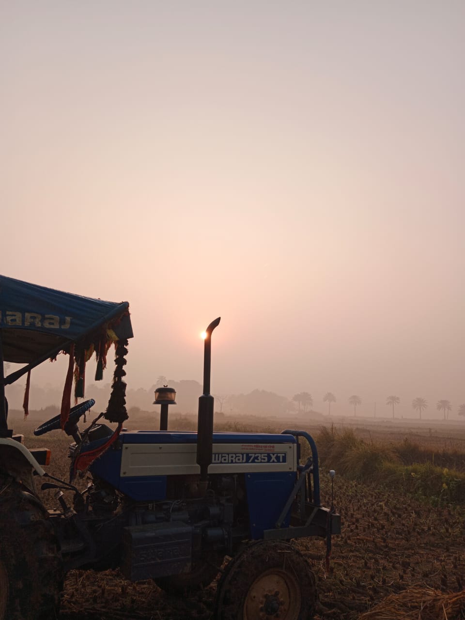 Tractor at Sunrise in Field